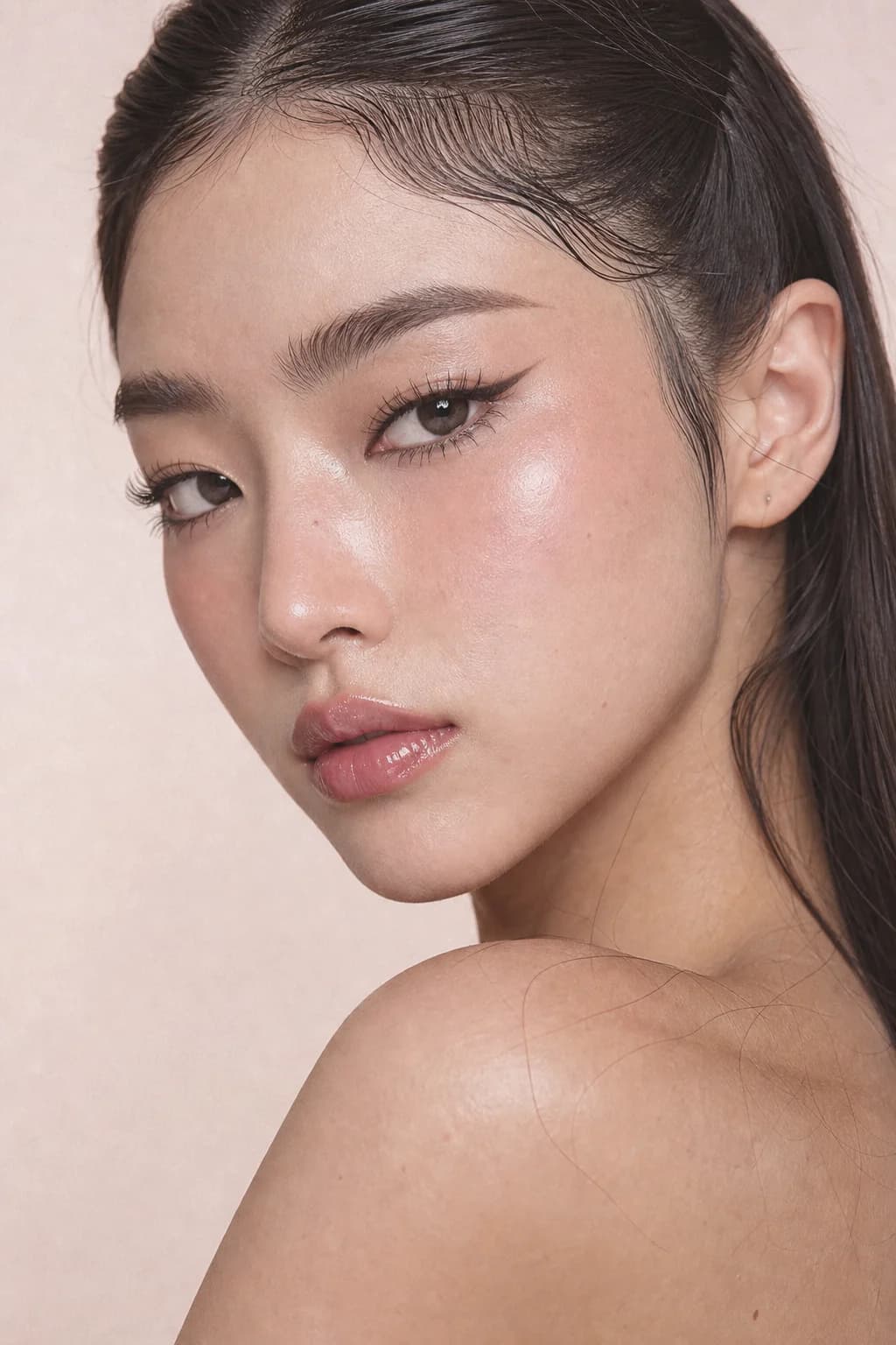 Bare, glowing skin with soft wispy lashes in natural daylight
